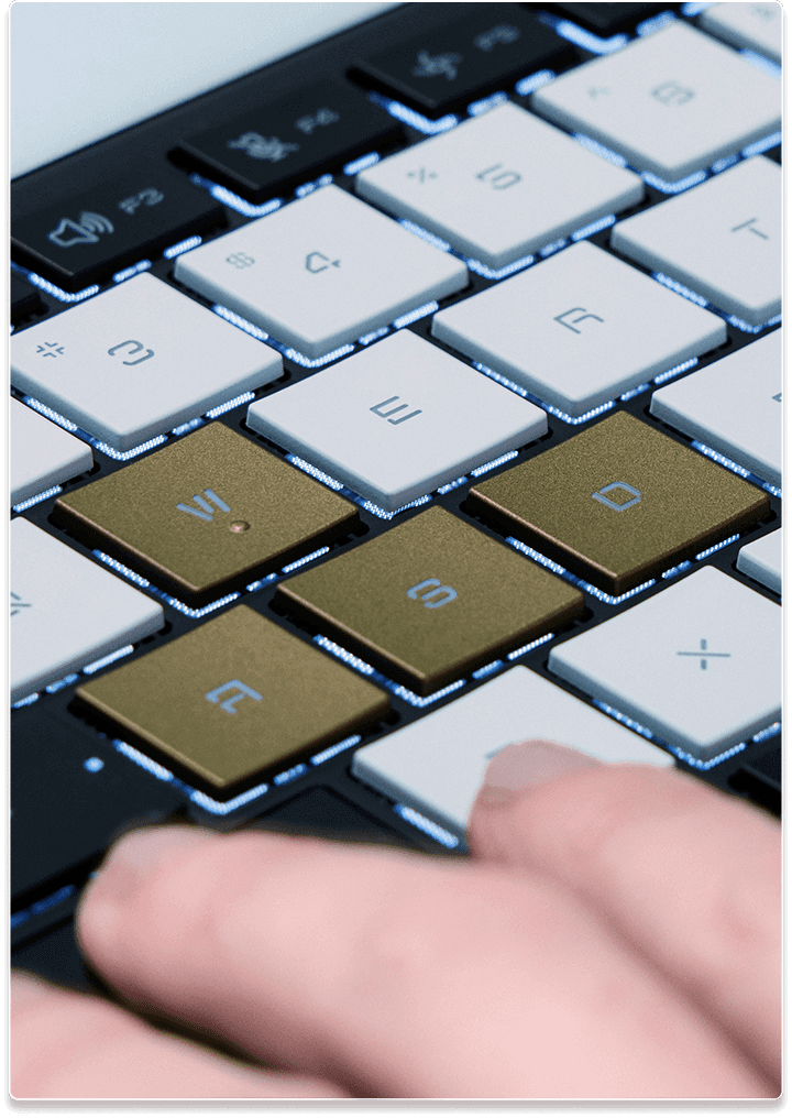 A closeup of the white and golden keycaps of the Flow Z13 laptop