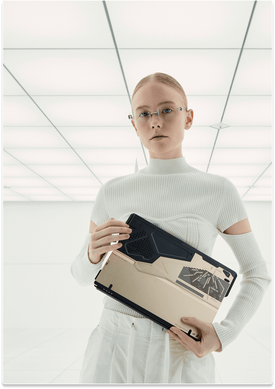 A woman in white clutching the Flow Z13 KJP laptop before her