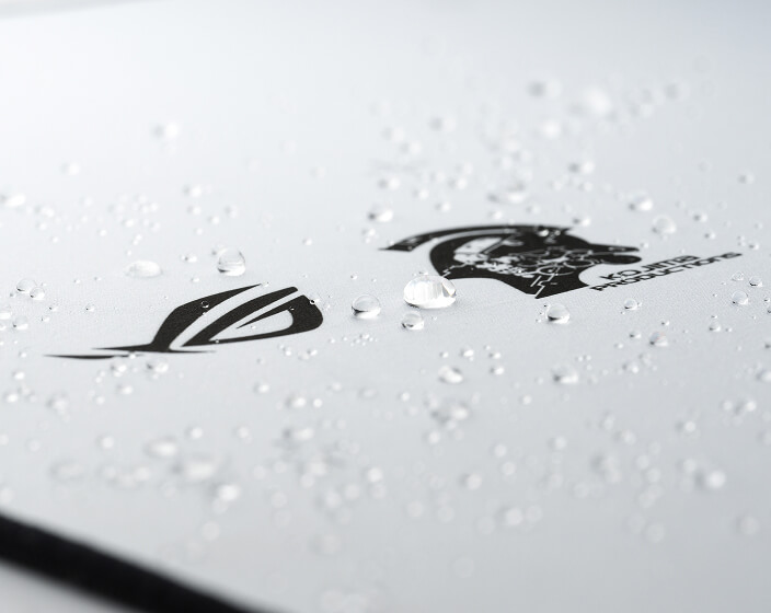 A closeup of a corner of the Scabbard II XXL KJP mousepad, where wated droplets are at the surface