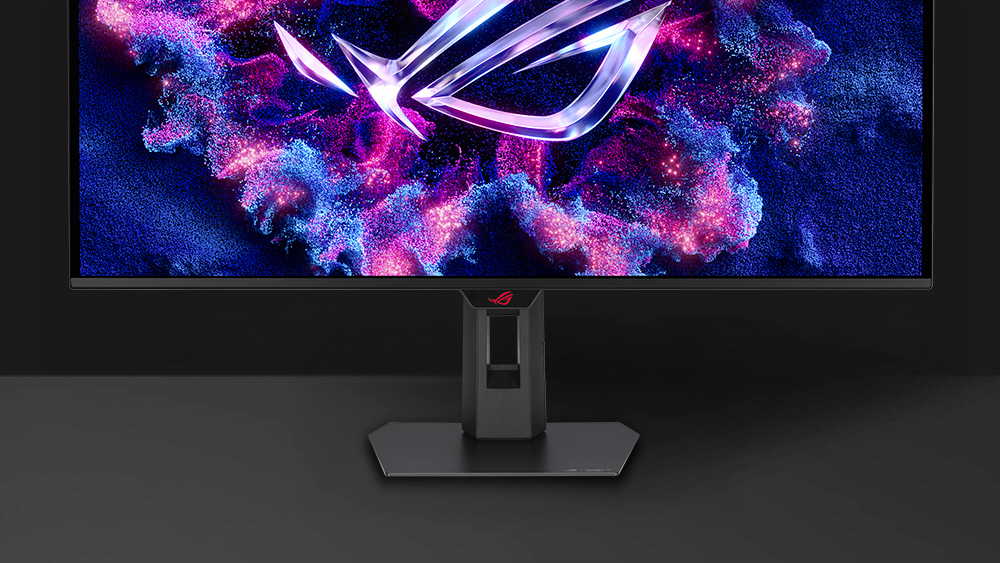The front image of XG32UQDMS with a mobile phone on device groove