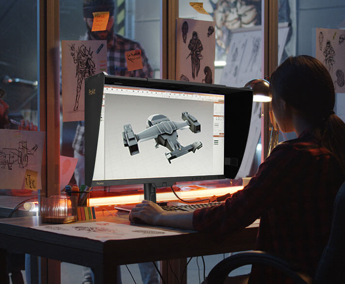 A creator working on the ProArt Display, sketching a futuristic spaceship concept.