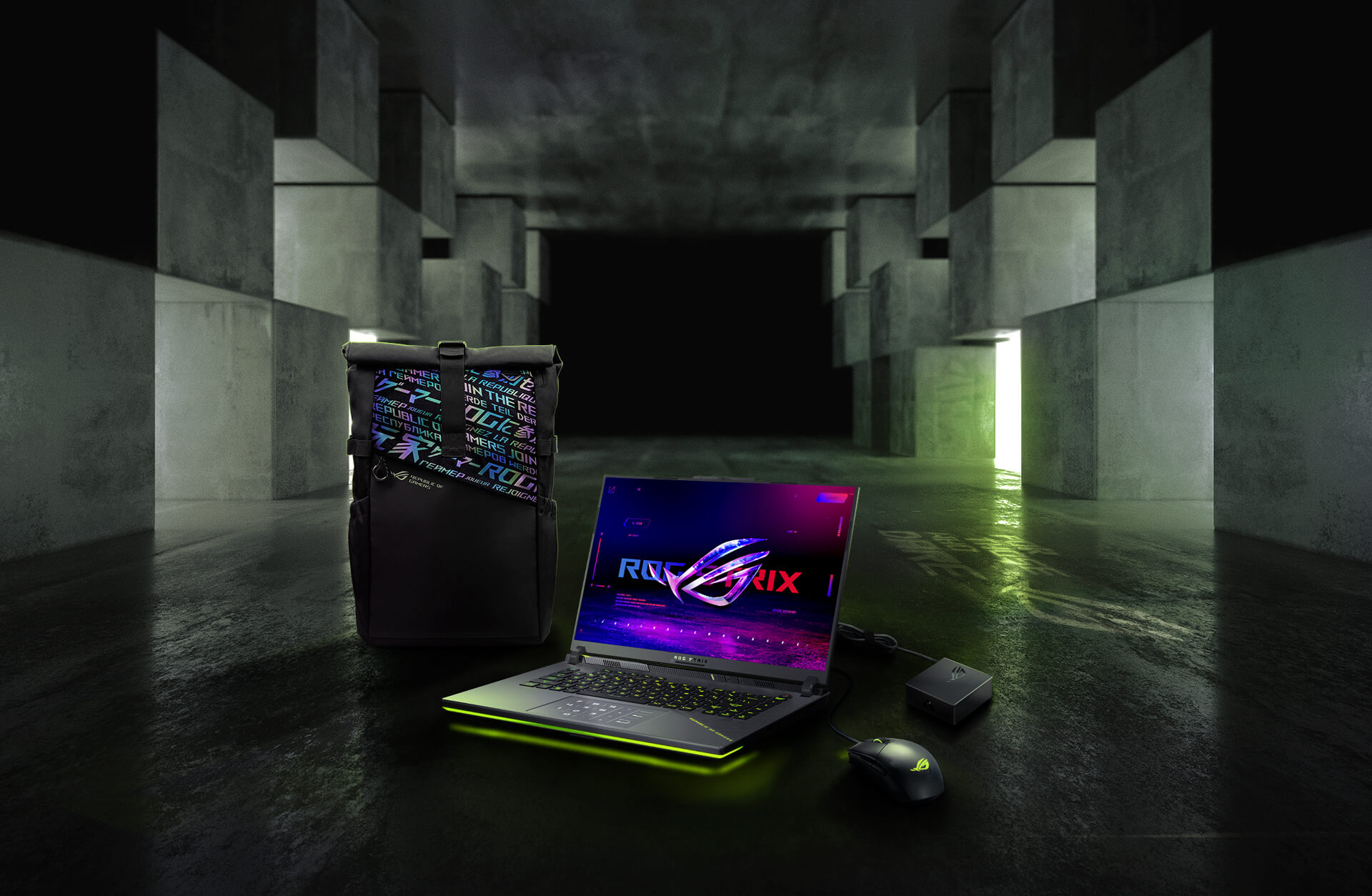 In an underground big space, from left to right; an ROG backpack, G16, ROG Strix Gladius III mouse, and 100W adapter.