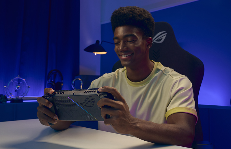 Gamer playing a VR game with a headset and controller in a colorful gaming setup.