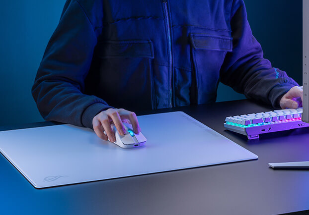 An image with a hand controlling a mouse on top of the ROG Moonstone Ace L Moonlight White