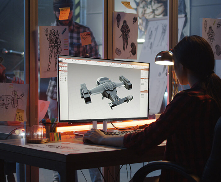 A creator working on the ProArt Display, sketching a futuristic spaceship concept.