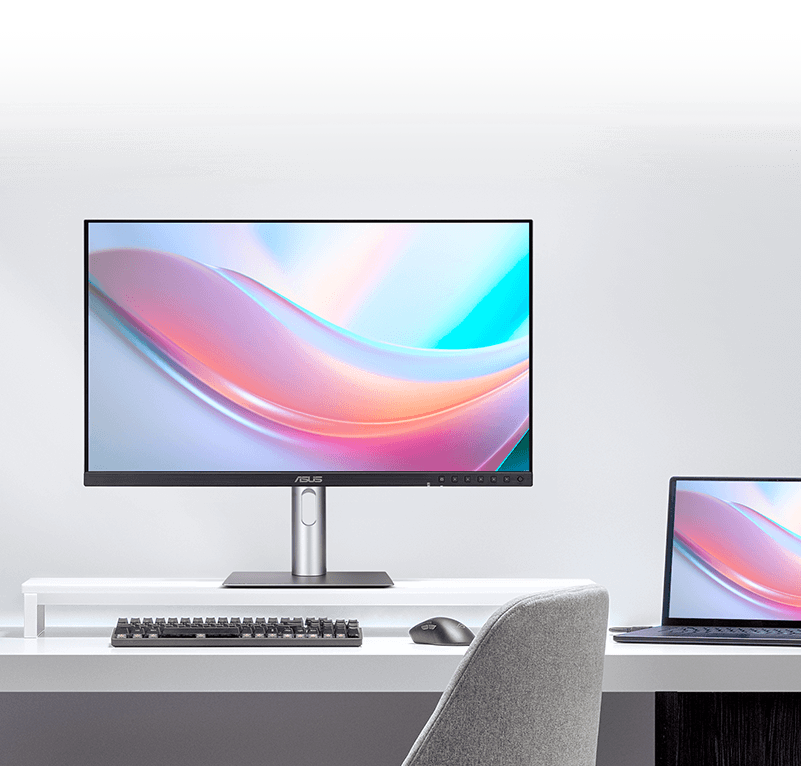 The ASUS monitor displaying vibrant colors next to a laptop screen, illustrating a consistent visual experience.